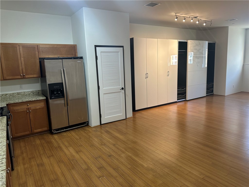 255 West 7th Street, Unit 13 San Pedro, CA 90731 - Photo 7 of 22 a view of a kitchen with wooden floor and electronic appliances