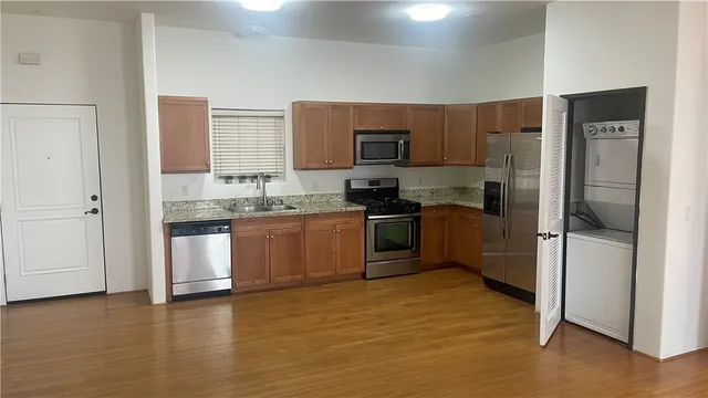 a kitchen with a refrigerator sink and cabinets