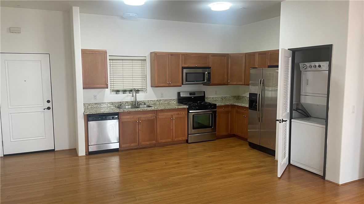 255 West 7th Street, Unit 13 San Pedro, CA 90731 - Photo 9 of 22 a kitchen with a refrigerator sink and cabinets