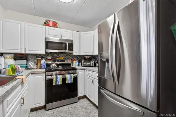 a kitchen with a refrigerator and a sink