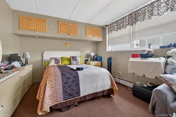 a bedroom with furniture and a large window