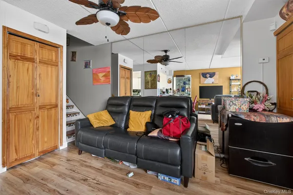 a view of a dining room with furniture a rug and wooden floor