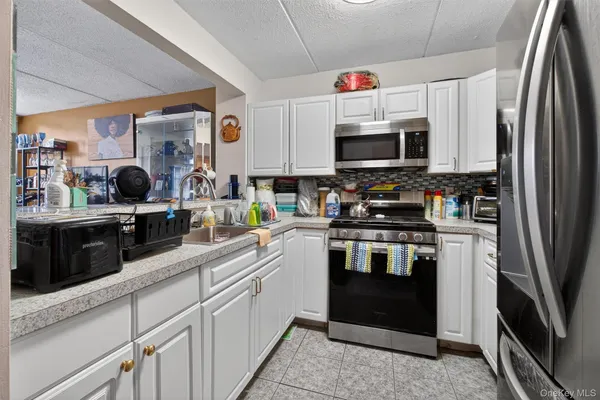 a kitchen with stainless steel appliances a refrigerator stove and microwave