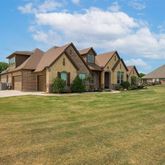 a front view of a house with a garden and yard