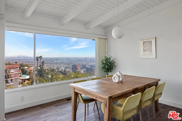 a view of a dining room with furniture window and wooden floor