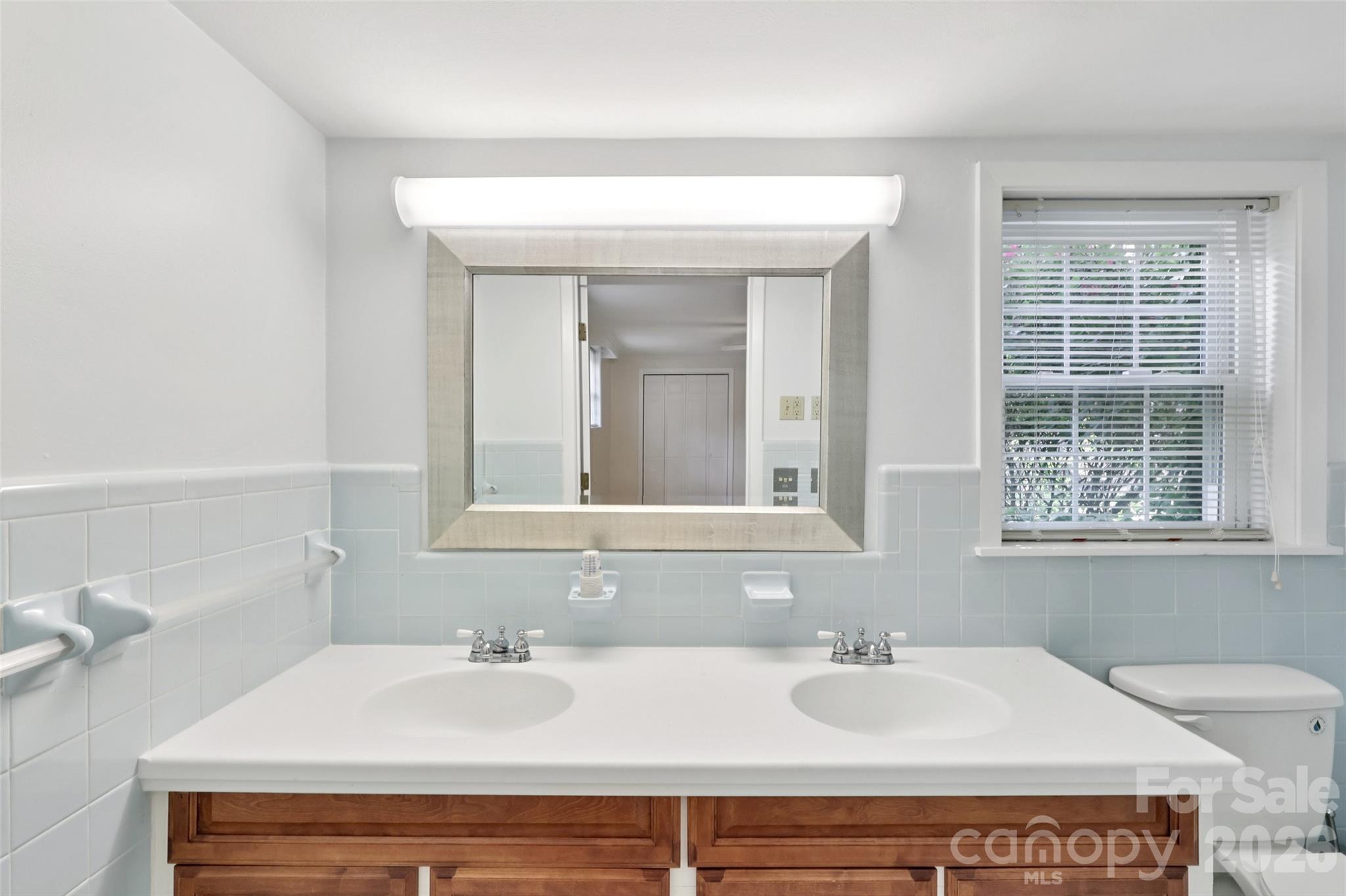 1002 Ridge Street Albemarle, NC 28001 - Photo 33 of 45 a bathroom with a sink and a mirror