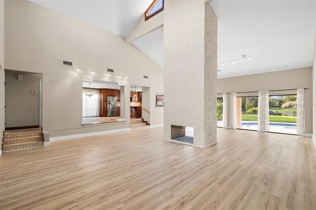 a kitchen with a table chairs refrigerator and microwave