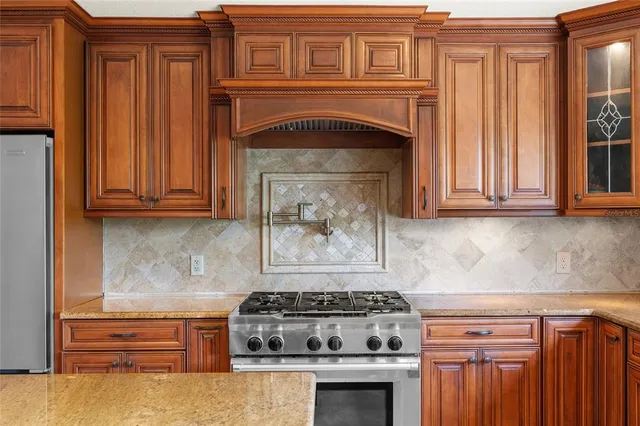 a spacious bathroom with a granite countertop double vanity sink a mirror and a bathtub