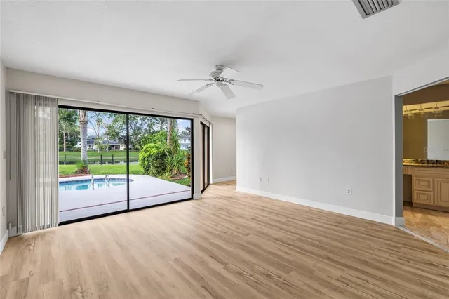 wooden floor in an empty room with a window
