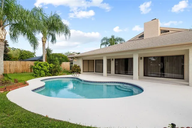 an aerial view of a house with a yard and lake view