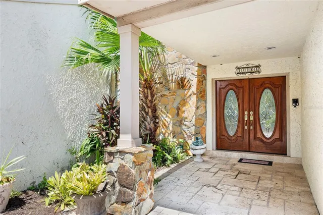 a couple of potted plant sitting in front of a door