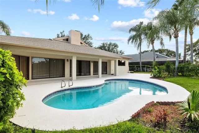 a view of a house with swimming pool and a porch