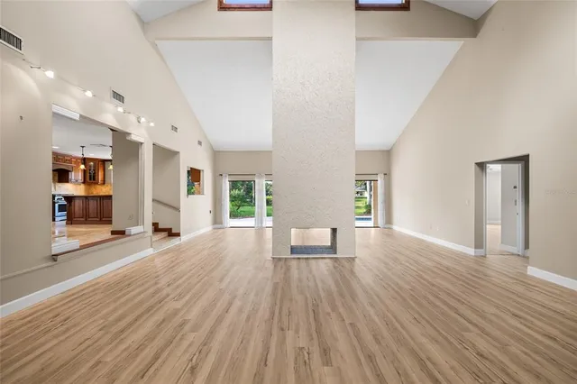 a view of a room with wooden floor and a window
