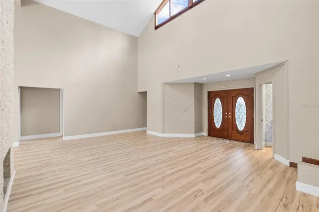 a view of an empty room with wooden floor with exposed radiator