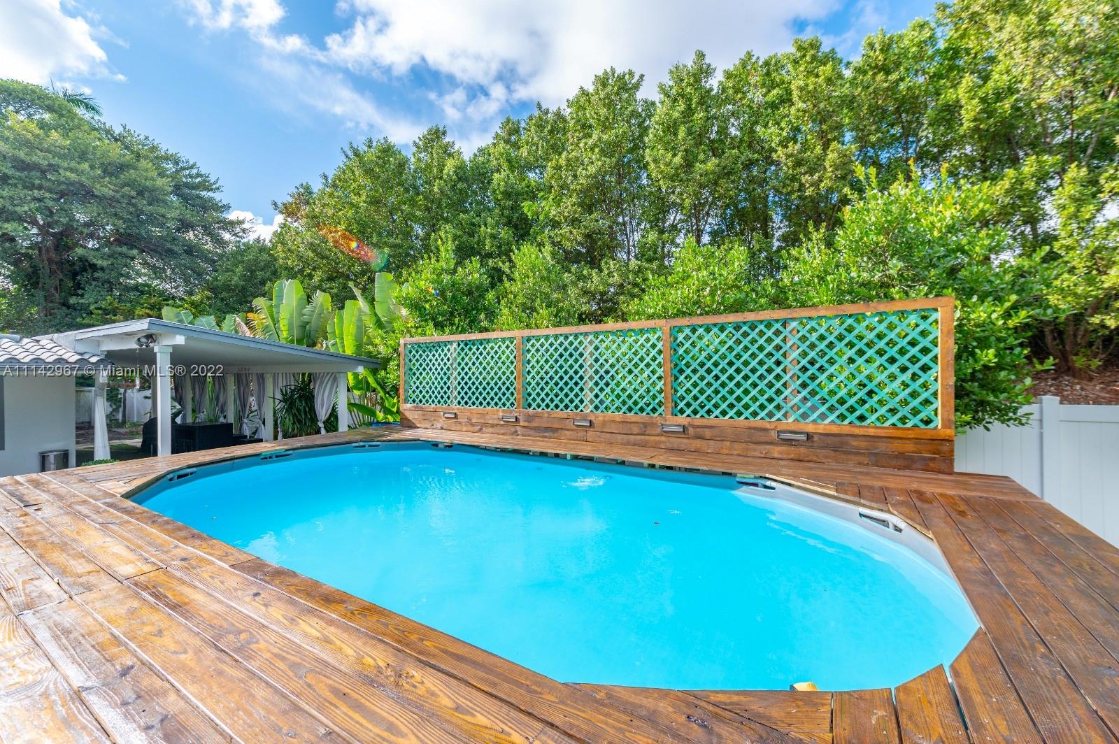 50 Southwest 21st Road Miami, FL 33129 - Photo 4 of 12 a view of a swimming pool with a patio
