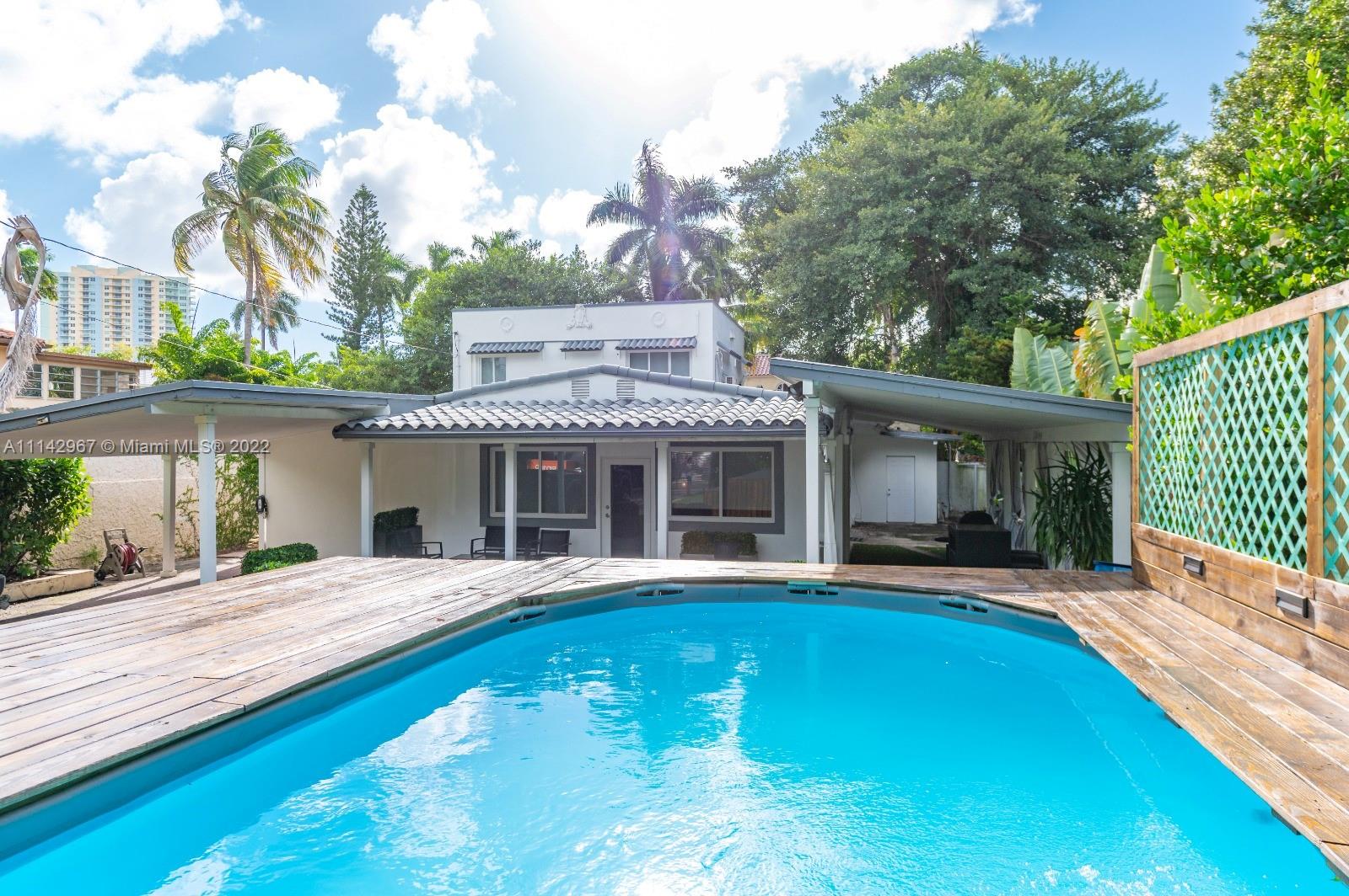 50 Southwest 21st Road Miami, FL 33129 - Photo 5 of 12 a front view of a house with swimming pool and porch with furniture