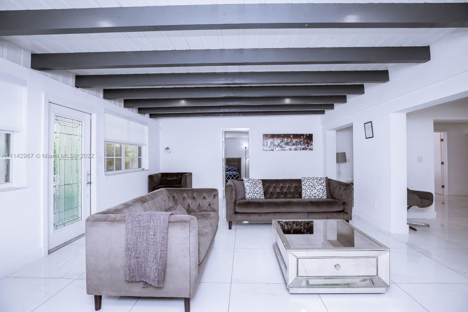 50 Southwest 21st Road Miami, FL 33129 - Photo 10 of 12 a living room with furniture and a flat screen tv
