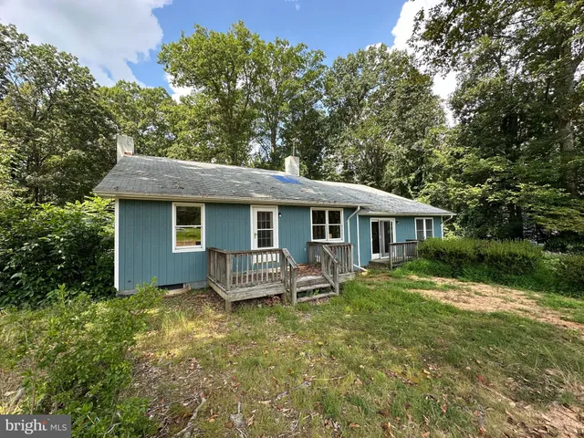 a view of a house with a yard chairs and a table and chair