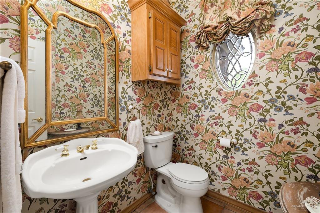 27603 Palo Verde Road San Benito, TX 78586 - Photo 11 of 45 a bathroom with a sink and mirror with toilet