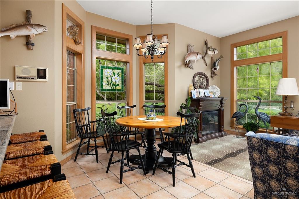 27603 Palo Verde Road San Benito, TX 78586 - Photo 13 of 45 a view of a dining room with furniture wooden floor and a chandelier
