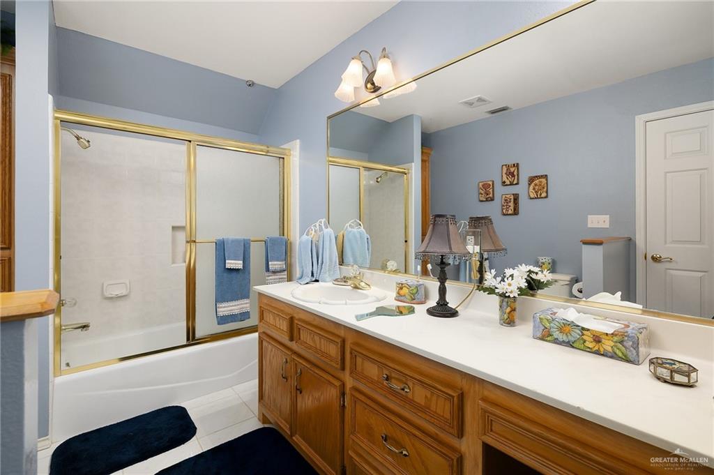 27603 Palo Verde Road San Benito, TX 78586 - Photo 27 of 45 a bathroom with a tub sink and mirror