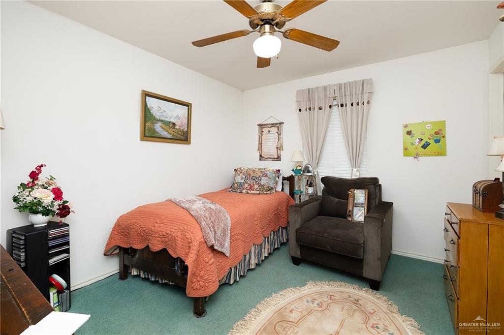27603 Palo Verde Road San Benito, TX 78586 - Photo 28 of 45 a bedroom with a bed furniture and a chandelier