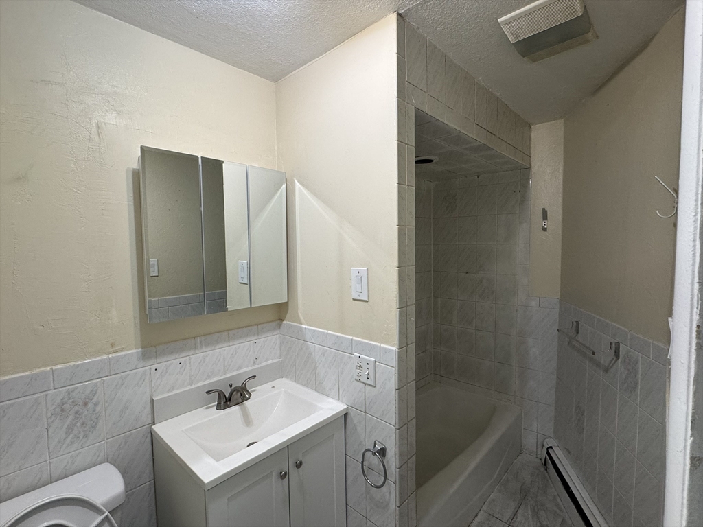 44 School Street Everett, MA 02149 - Photo 4 of 7 a bathroom with a sink toilet and shower