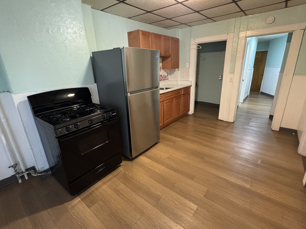 44 School Street Everett, MA 02149 - Photo 6 of 7 a kitchen with stainless steel appliances granite countertop a refrigerator and a stove