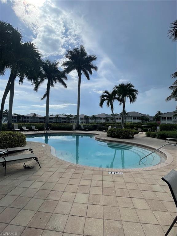 7168 Lemuria Circle, Unit 1701 Naples, FL 34109 - Photo 34 of 39 Community pool with a patio and a residential view