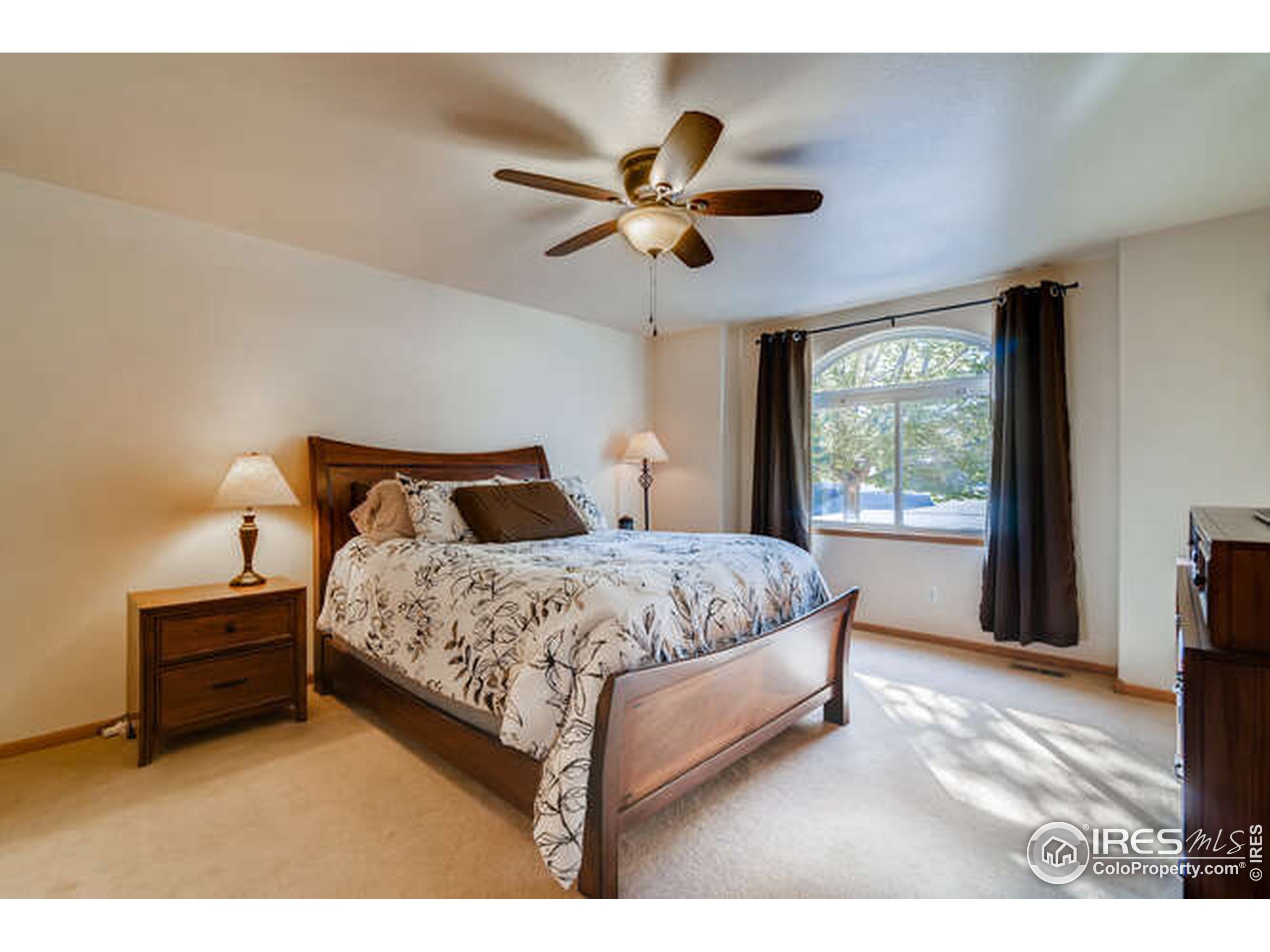 206 Victoria Street Berthoud, CO 80513 - Photo 12 of 29 a bedroom with a bed and a ceiling fan