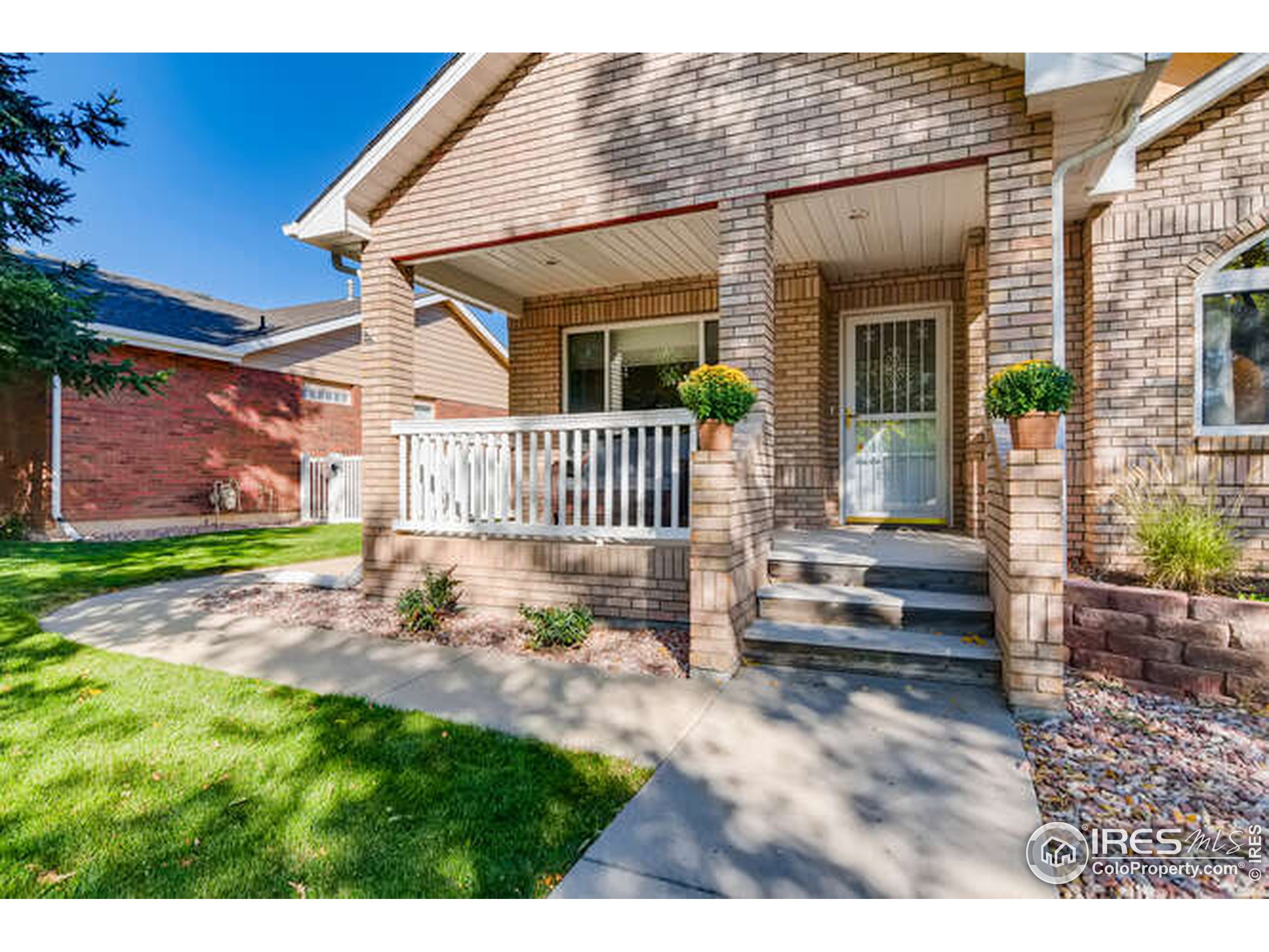 206 Victoria Street Berthoud, CO 80513 - Photo 2 of 29 a view of a house with wooden deck and furniture