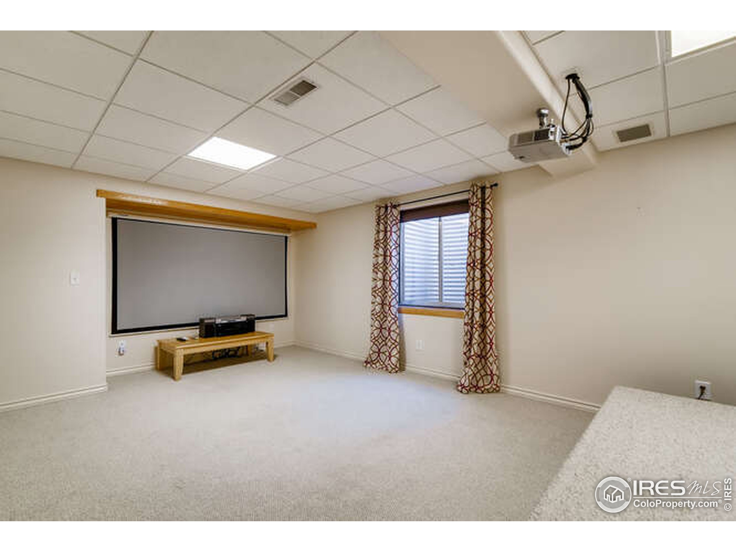 206 Victoria Street Berthoud, CO 80513 - Photo 22 of 29 a room with gym equipment and a flat screen tv