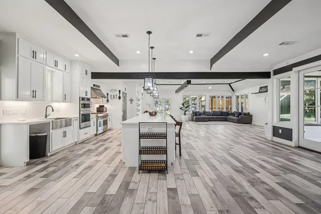 a view of kitchen with cabinets and wooden floor