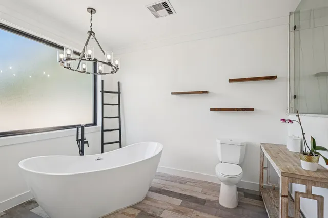 a white bath tub sitting next to a white toilet and sink