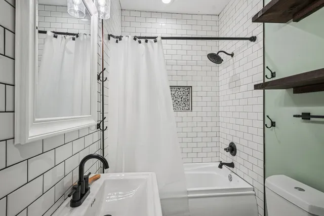a bathroom with a sink a bathtub and shower