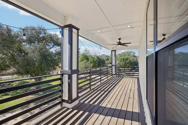 a view of a balcony with wooden floor