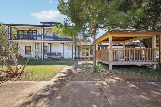 a view of a house with a yard and sitting area