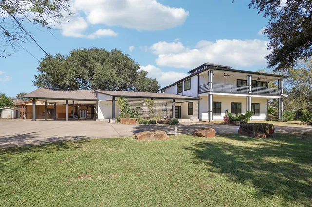 a front view of a house with a garden and sitting area