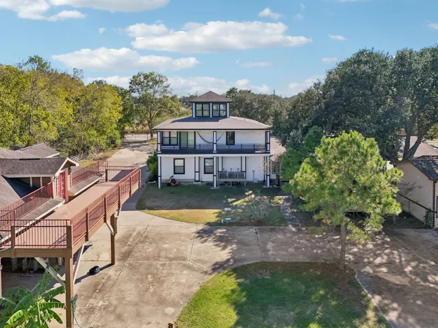 a view of a house with a yard and sitting area