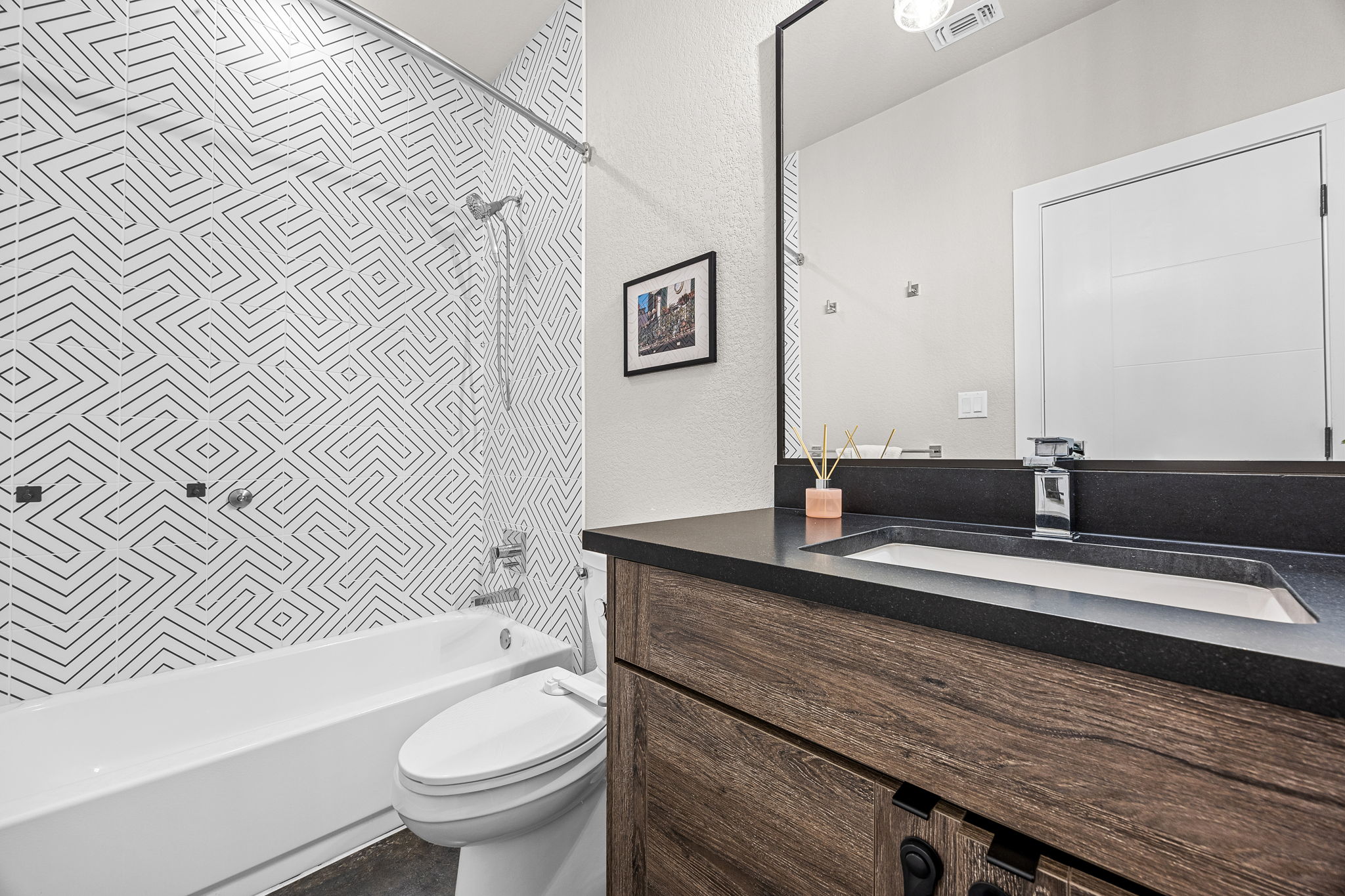 408 Martin Luther King Jr Street Georgetown, TX 78626 - Photo 19 of 35 a bathroom with a granite countertop sink a toilet a mirror and shower