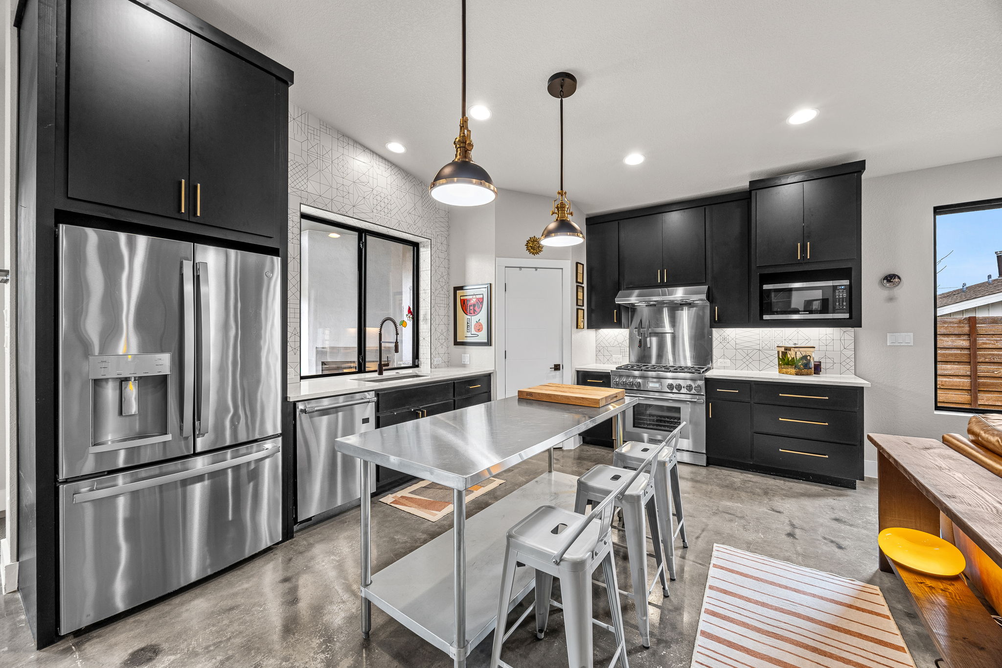 408 Martin Luther King Jr Street Georgetown, TX 78626 - Photo 7 of 35 a kitchen with stainless steel appliances kitchen island granite countertop a refrigerator a stove a sink a dining table and chairs with wooden floor