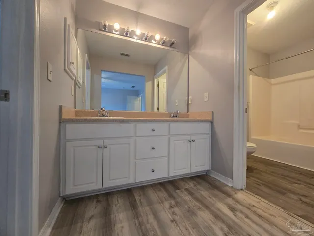 a view of a double vanity sink and a mirror in a room