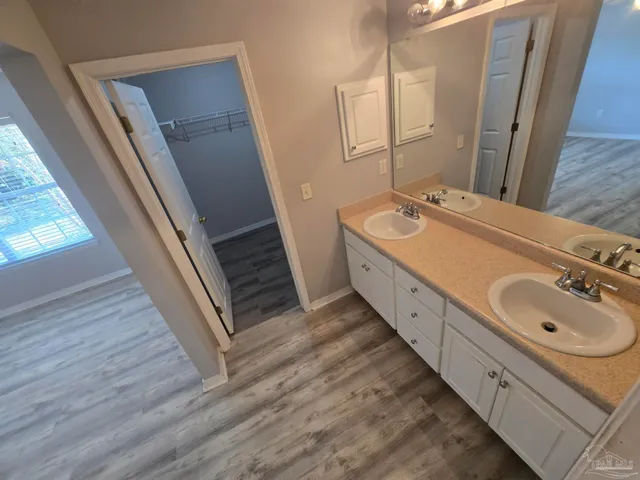 a bathroom with a double vanity sink and mirror