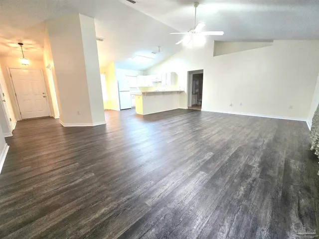 a view of a kitchen with wooden floor and a sink