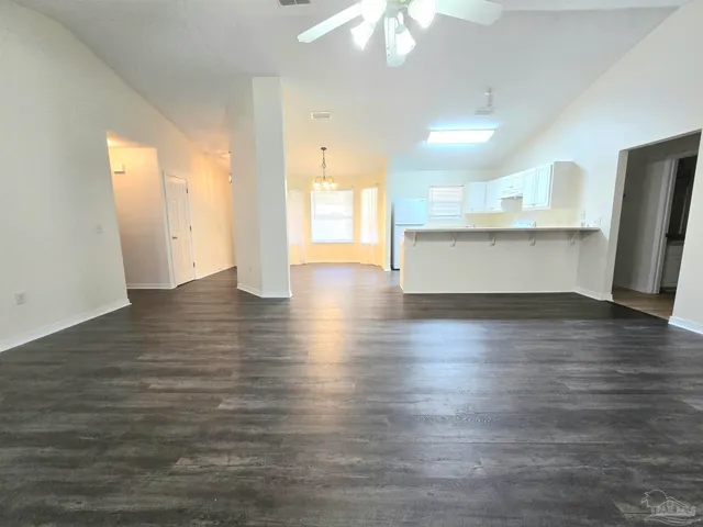 a view of a kitchen with wooden floor and a sink