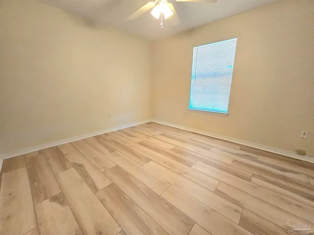 a view of a kitchen with wooden floor and a sink