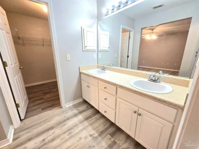 a spacious bathroom with a double vanity sink and a mirror