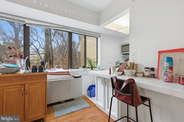 a kitchen with stainless steel appliances kitchen island granite countertop a stove and cabinets