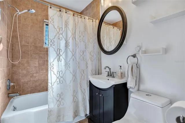 a bathroom with a sink toilet and a mirror