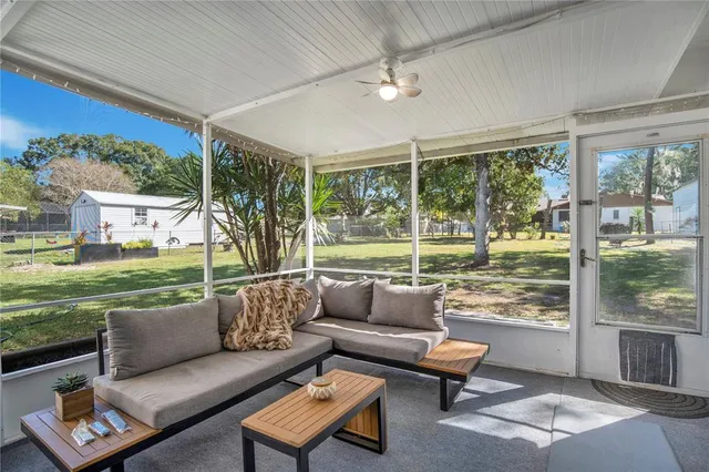 a living room with furniture a dining table and a large window